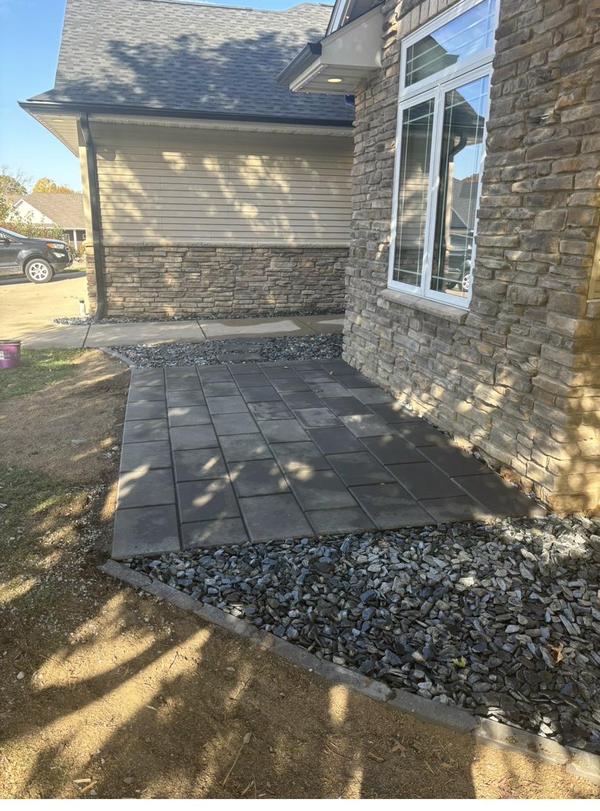 Cedar mulch covering a residential flower bed around green shrubs in Eastern Iowa